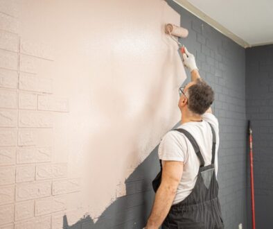 Man,Painting,Brick,Wall,With,Paint,Roller