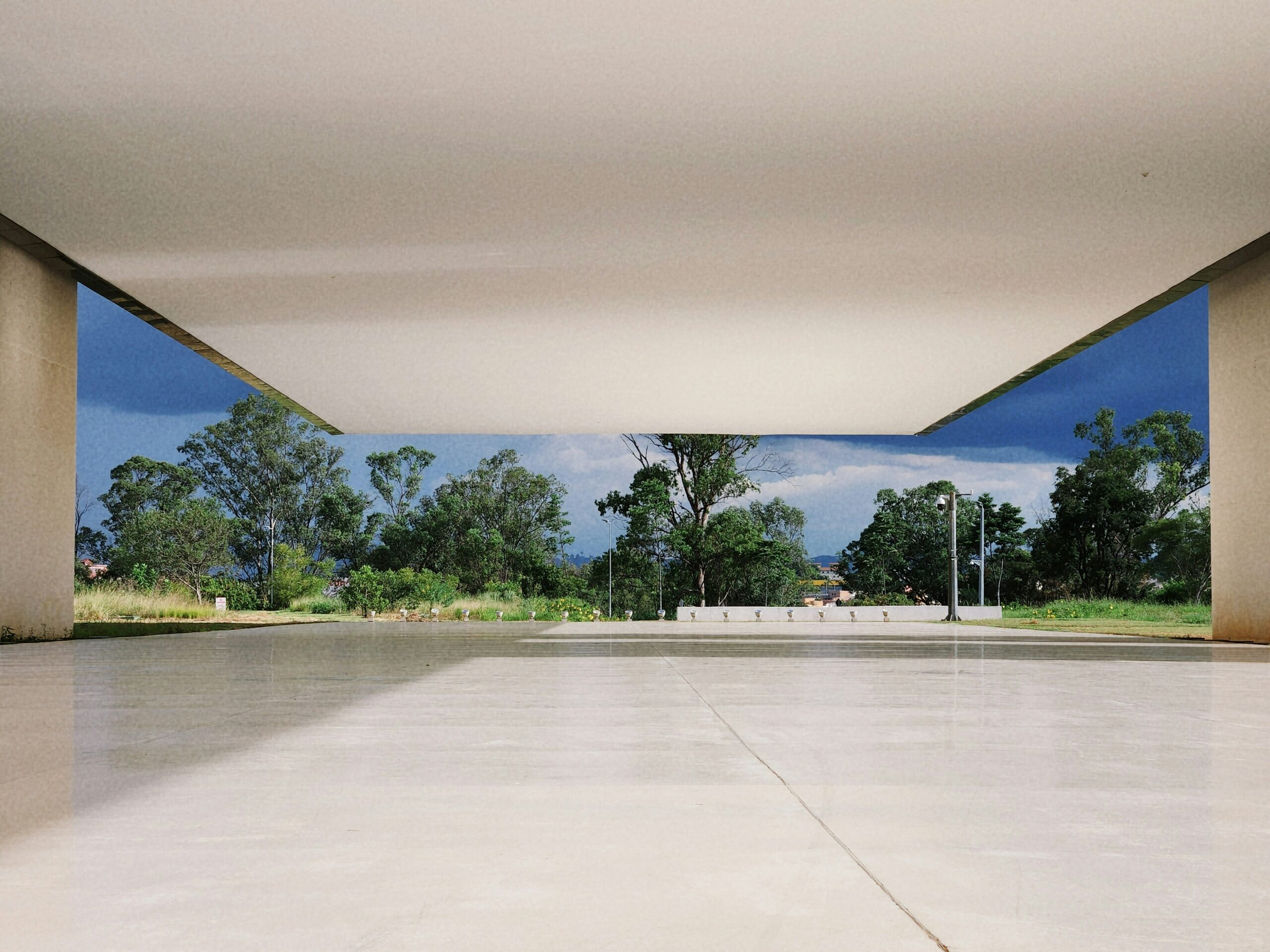 An empty concrete floor that looks out over a park